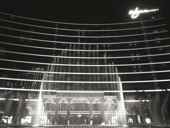 Low angle view of light trails on wall at night