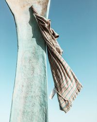 Low angle view of sculpture against clear blue sky
