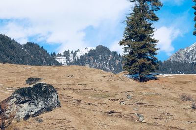 Scenic view of rocks on landscape against sky