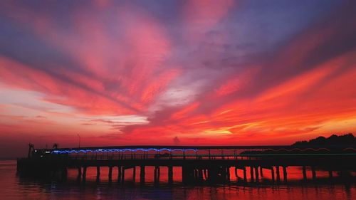 Pier over sea against sky during sunset