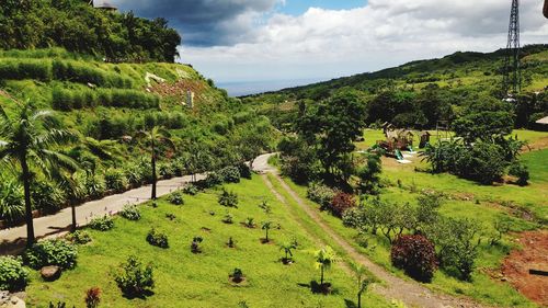 High angle view of green landscape against sky