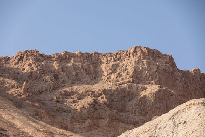 Rock formations on landscape against clear sky