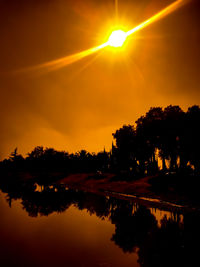 Scenic view of lake against orange sky