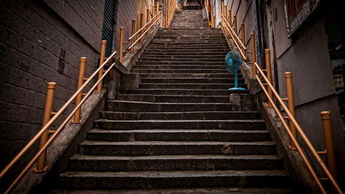 Low angle view of staircase amidst buildings