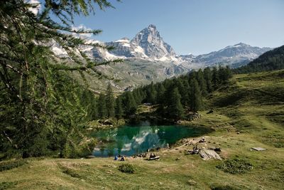 Scenic view of lake by mountains against sky