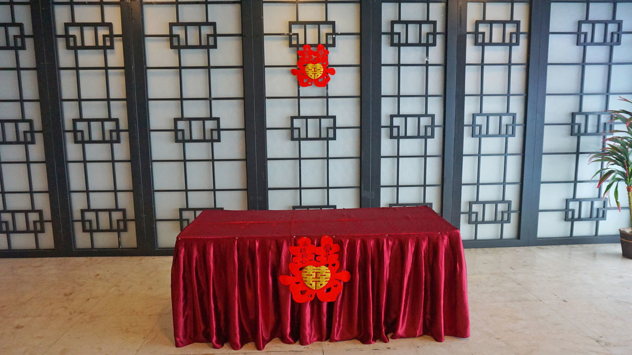 RED LANTERN ON BUILDING BY WALL