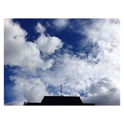 Low angle view of building against cloudy sky