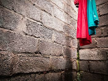 Red and blue clothes with bricks background