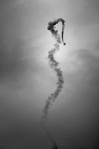 Low angle view of airplane flying against sky