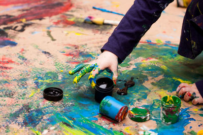 Little girl painting with hands 