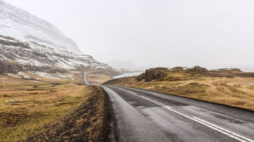 Road along mountain against sky