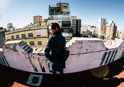 Low angle view of woman standing in roof