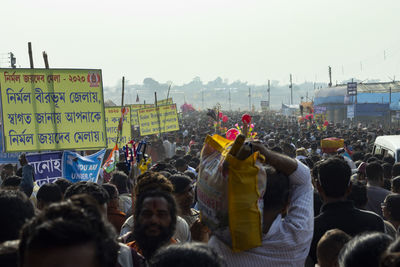 People on street in city against sky