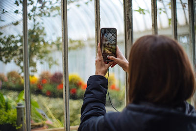Rear view of woman using mobile phone