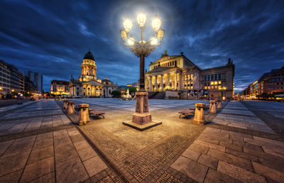 Statue in city at night