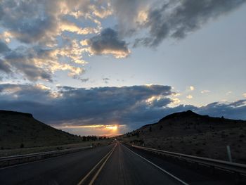 Highway against sky during sunset