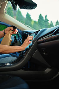 Low section of man driving car