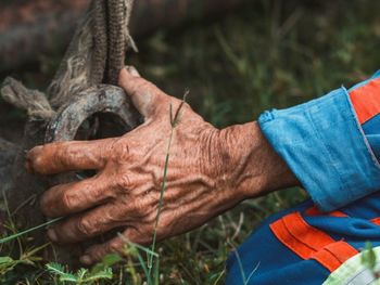 Low section of man standing on grass