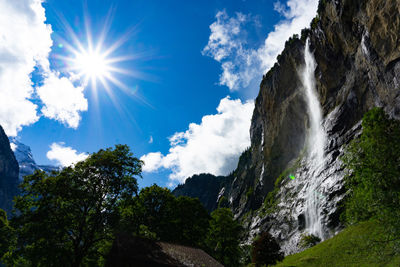 Low angle view of waterfall against sky