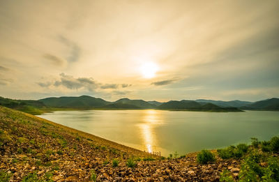 Scenic view of lake against sky during sunset