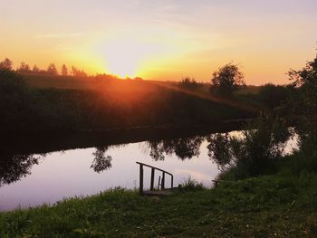 Scenic view of lake against sky during sunset