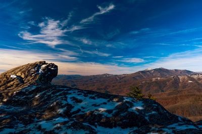 Scenic view of snowcapped mountains against blue sky