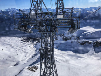 Snow covered land and mountains against sky