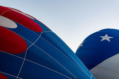 Low angle view of flag against clear blue sky