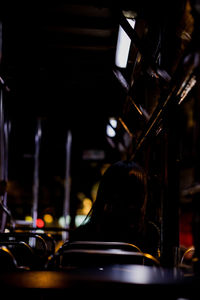 Rear view of woman sitting in bus