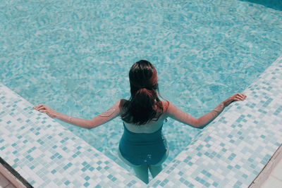 Rear view of woman in swimming pool