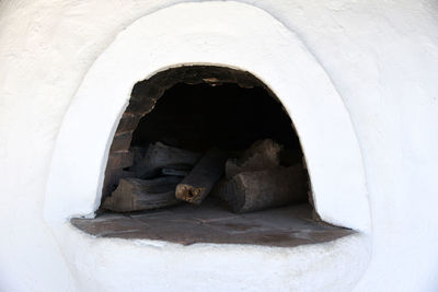 Cat looking through window of old building