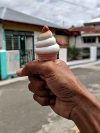 Close-up of hand holding ice cream cone