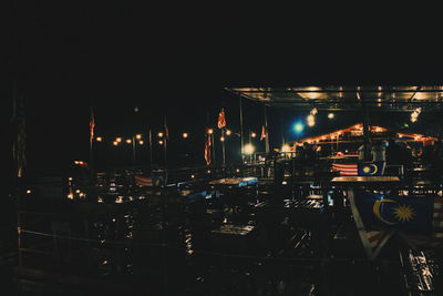 Illuminated cityscape against sky at night