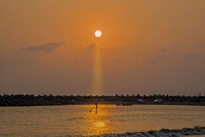 Scenic view of sea against orange sky