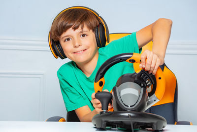 Portrait of boy playing with toy on table