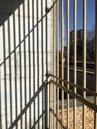 Metal fence and its shadow on the wall