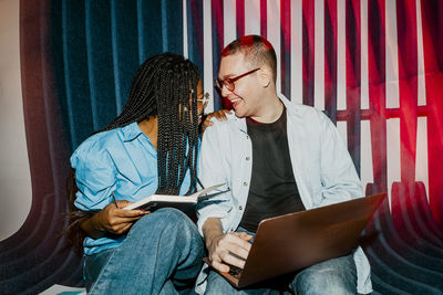 Happy multiracial male and female entrepreneurs with face to face