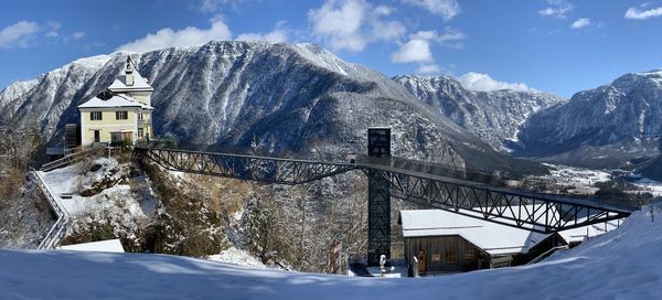 Snow covered buildings against sky in hallstatt austria 