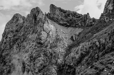 Low angle view of rocky mountain against sky