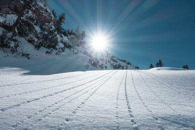 Snow covered landscape against sky