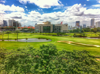 Buildings in city against cloudy sky