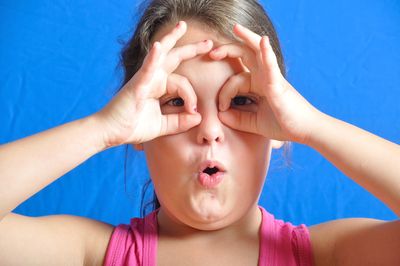 Close-up portrait girl against colored background