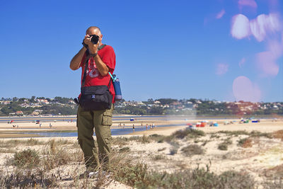 Side view of woman standing at beach