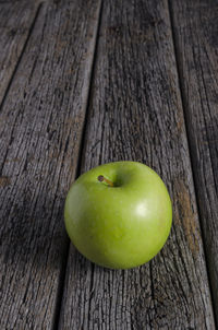 Close-up of apple on tree trunk