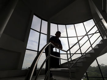 Low angle view of man standing on staircase