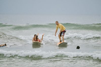 Rear view of shirtless man swimming in sea