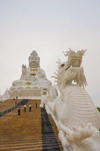 Statue of temple against building