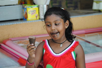 Girl looking at chocolate ice cream cone