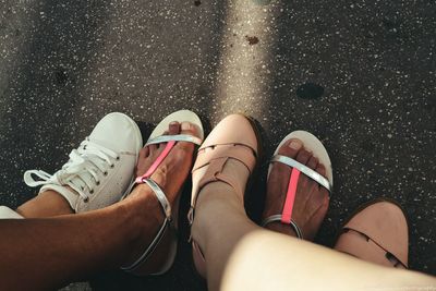 Low section of friends standing on road