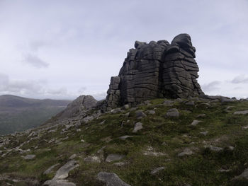 Rock formations on landscape against sky